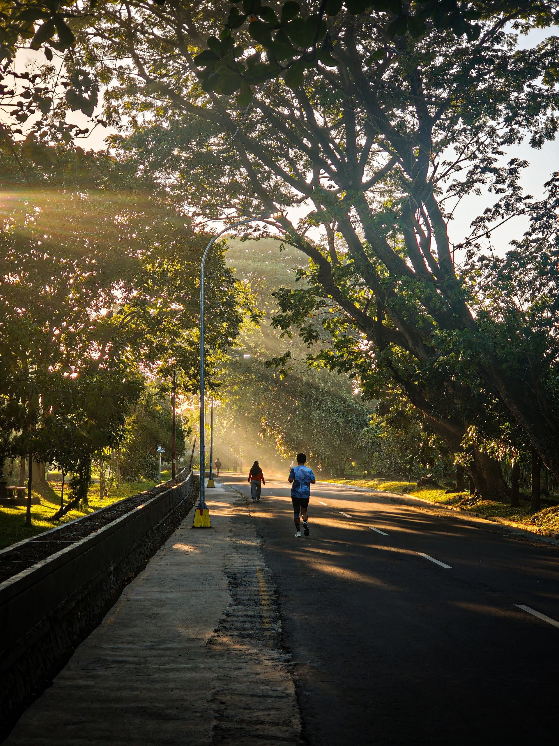 Runner on a quiet road at sunrise